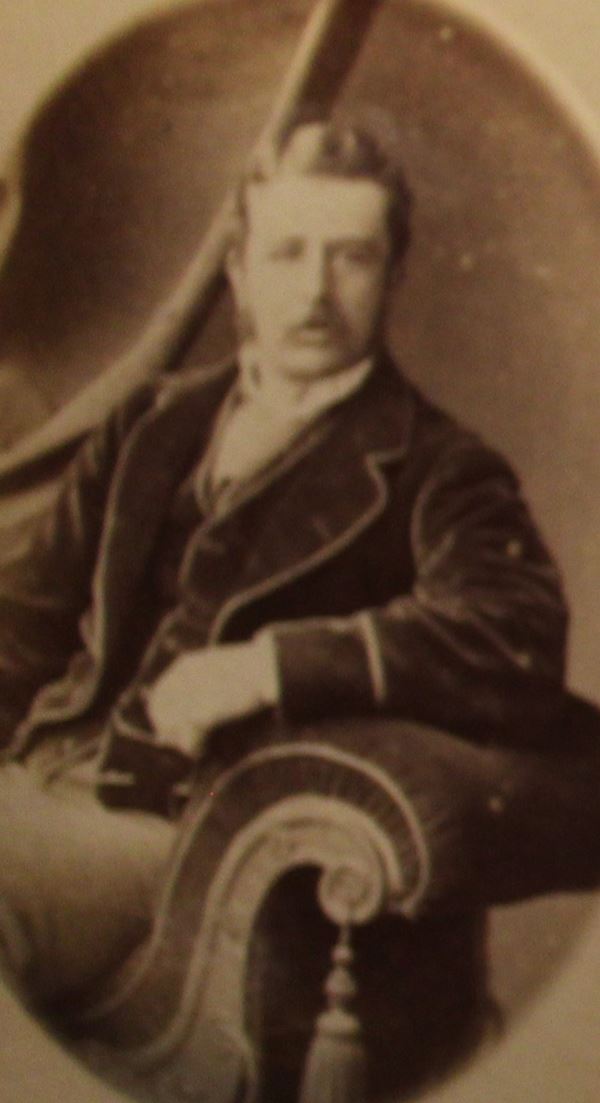 photo of a man posing casually in a velvet jacket